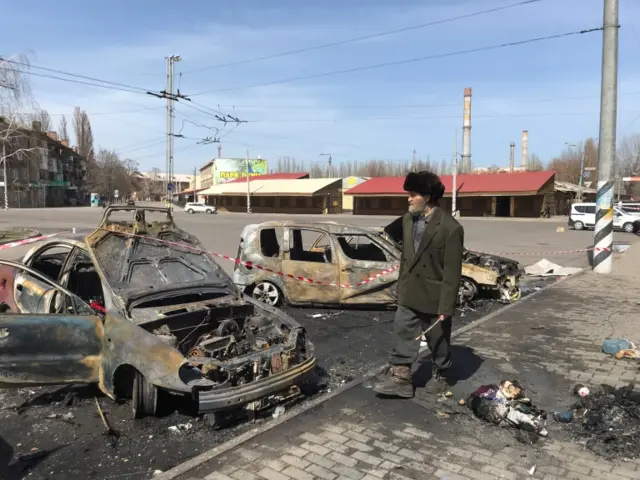 A man walks past destroyed cars in Kramatorsk after a rocket attack. Photo: 8 April 2022