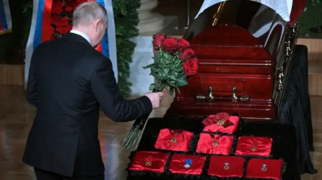 Vladimir Putin lays flowers by the casket of Russian ultranationalist politician Vladimir Zhirinovsky