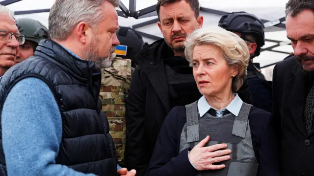 Ursula von der Leyen holds her hand to her heart as she speaks with Bucha Mayor Anatolii Fedoruk