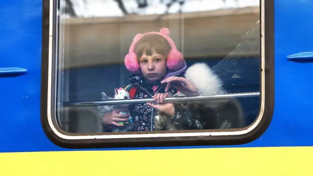 A child looks out of the window of a train as it arrives in Lviv from Zaporizhzhia, 5 April 2022