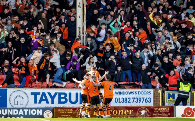 Dundee United players celebrate the opener in front of their fans