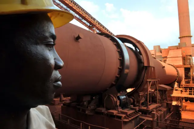 A man at a bauxite factory in Guinea.