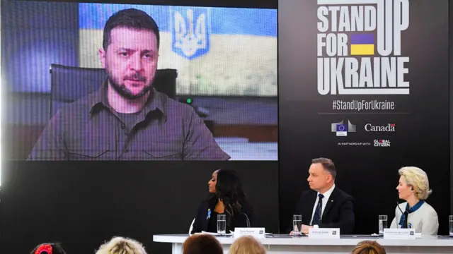 A screen at the Stand Up For Ukraine event with an image of Ukraine's President Zelensky