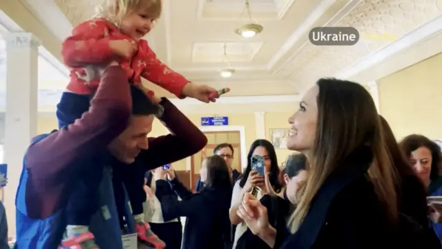 Angelina Jolie meets a child at Lviv's railway station