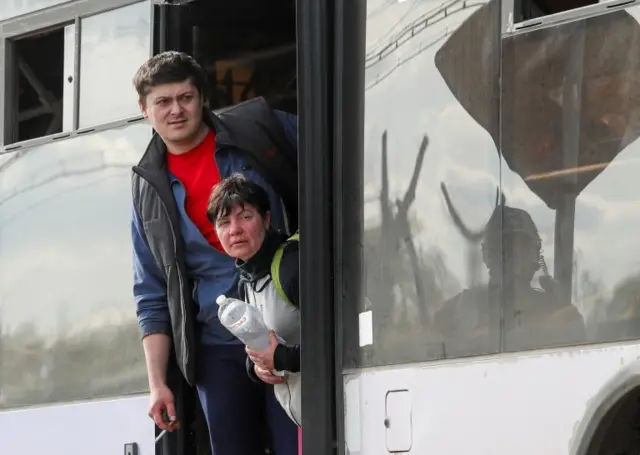 Civilians who left the area near Azovstal steel plant in Mariupol look out of a bus