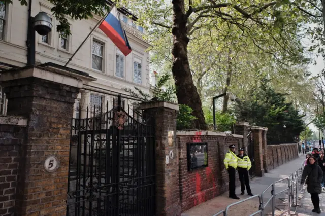 London Metro Police officers stand on guard outside the Russian Federation Embassy in London