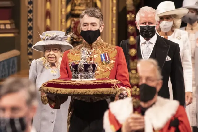 Queen Elizabeth II accompanied by the Prince of Wales