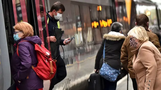 People getting on and off a train