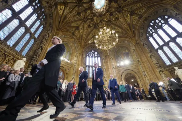 Prime Minister Boris Johnson (center left) and the leader of the Labour Party Keir Starmer walk through the Central Lobby