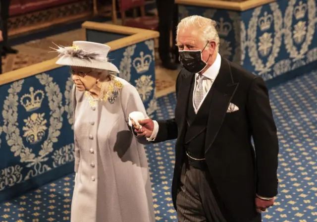 Queen Elizabeth II accompanied by the Prince of Wales