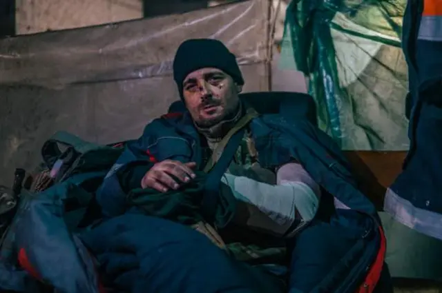 A wounded Azov fighter wrapped up in a sleeping bag