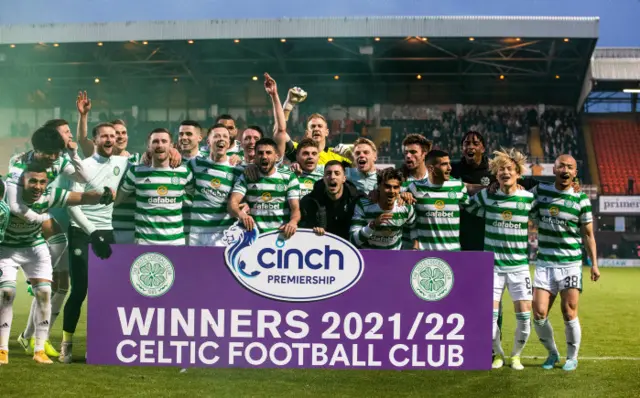 Celtic players celebrate their achievement on the Tannadice pitch