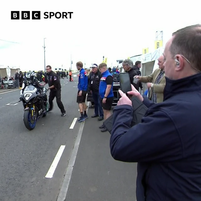 Philip McCallen snaps a pic of Micahel Dunlop during practice