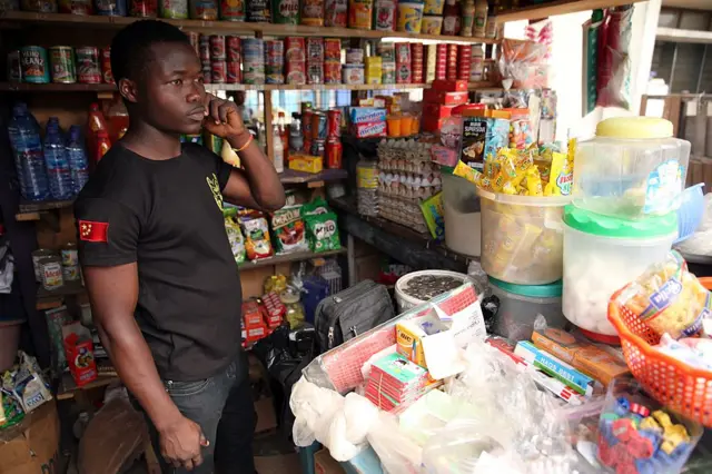 Kingsley Adukpo stands in his shop in Accra