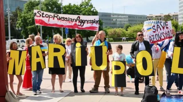 Protesters outside UN Human Rights Council session in Geneva, 12 May 2022