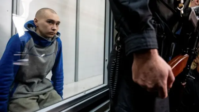 Vadim Shishimarin inside a defendants cage in Kyiv, Ukraine