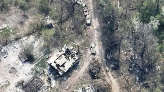 Destroyed buildings and burnt vehicles on the banks of Siverskyi Donets River