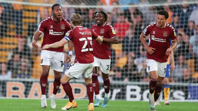 Northampton celebrate their first goal at Mansfield