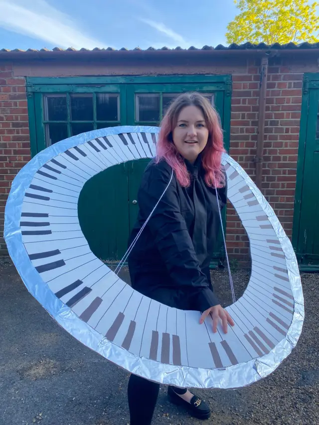 Abi wears a homemade circular keyboard