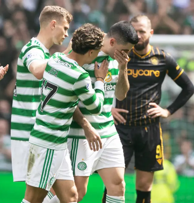 Celtic players with an emotional Tom Rogic