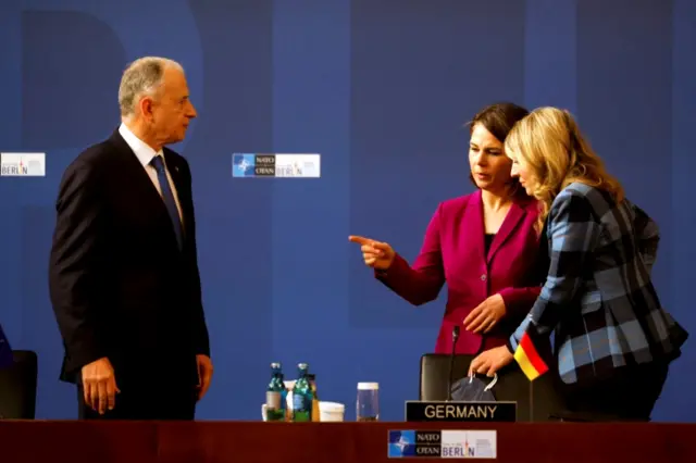 Annalena Baerbock and Melanie Joly speaking to Nato Deputy Secretary General Mircea Geoana