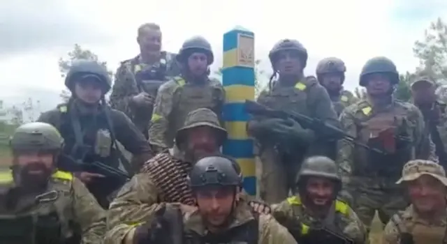 Ukrainian troops stand at the Ukraine-Russia border in what was said to be the Kharkiv region, Ukraine in this screen grab obtained from a video released