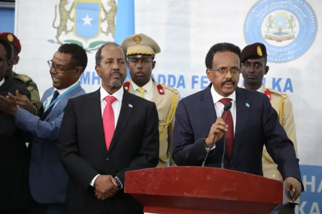 Incumbent President Mohamed Abdullahi Mohamed (right), also known as Farmajo speaks after Somalia's new president Hassan Sheikh Mohamud swore in