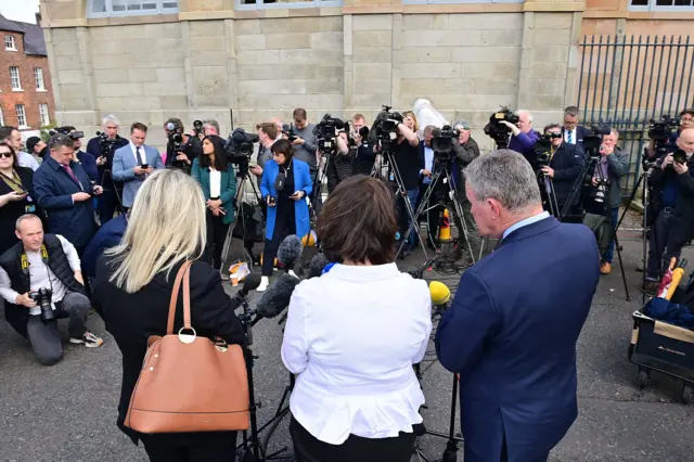 Mary Lou McDonald, Michelle O'Neill and Conor Murphy surrounded by media