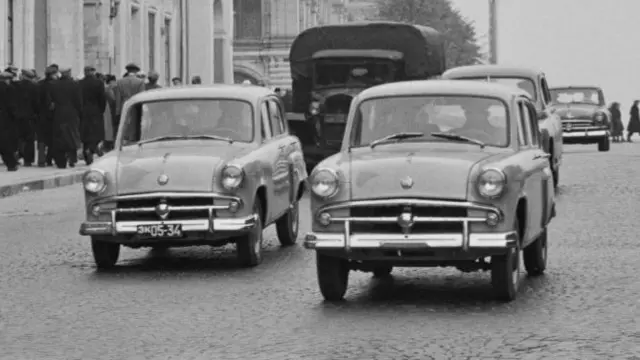 Black and white image of two Moskvich cars in Moscow