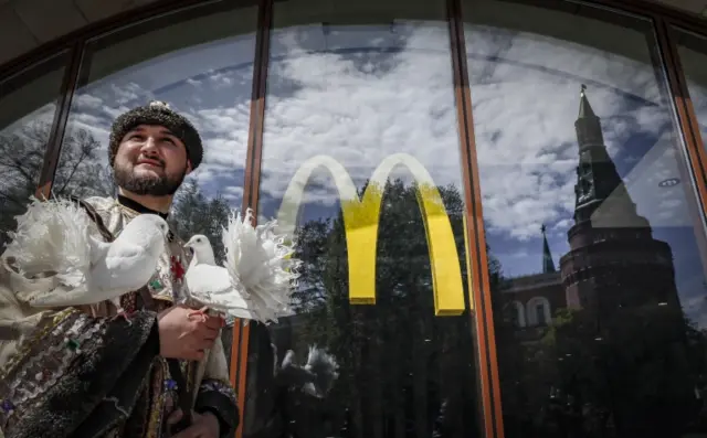 A street actor stands near a closed McDonalds restaurant in Moscow, Russia