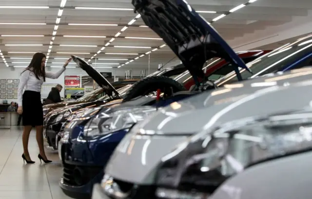 An employee works at a Renault cars sales and showroom in Moscow (February 2013)