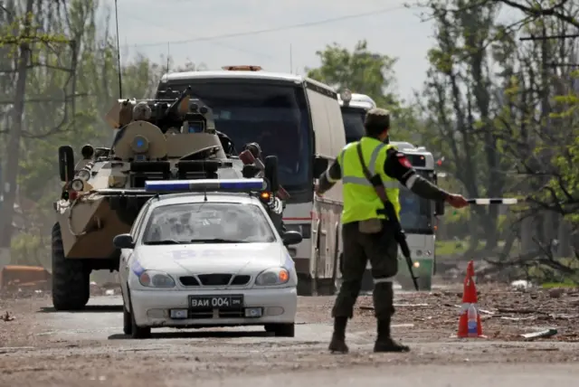 Buses carrying service members of Ukrainian forces who have surrendered after weeks holed up at Azovstal steelworks