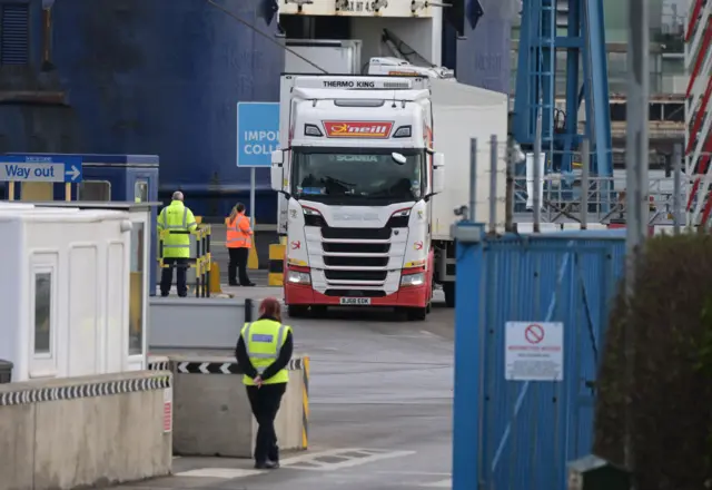 A customs official watched on as freight and goods lorries disembark from the Cairnryan, Scotland to Larne, Northern Ireland ferry without goods checks by customs officials on February 3, 2022 in Larne, Northern Ireland.