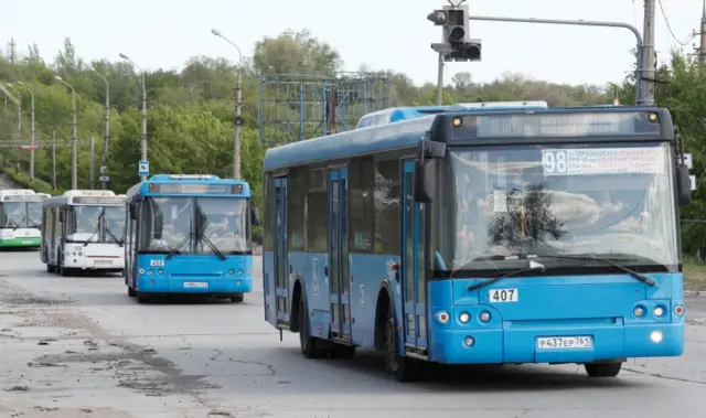 Buses carrying members of Ukrainian forces who have surrendered after weeks holed up at Azovstal steelworks drive away under Russian escort