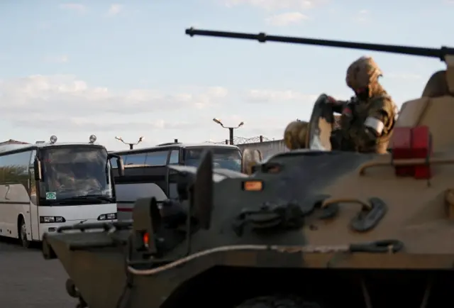 Buses carrying Ukrainian soldiers evacuated from Azovstal arrive under Russian escort at a detention centre in Olenivka in t,he Donetsk Region