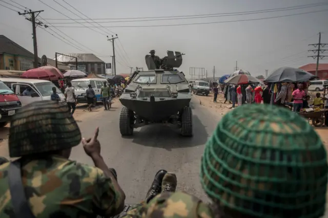 Nigerian soldiers and military convoy drive in Aba, in a pro-Biafra separatists zone, southeastern Nigeria, on February 15, 2019