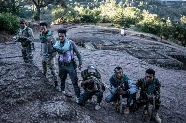 Amhara Fano militia fighters pose at Saint George Church in Lalibela, on December 7, 2021