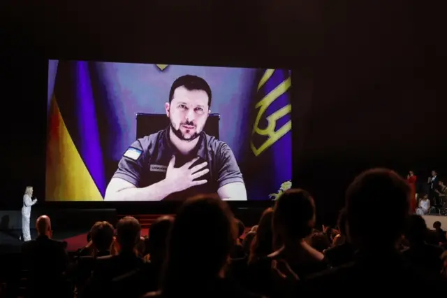 Volodymyr Zelensky addresses the audience at the Cannes Film Festival on a large screen