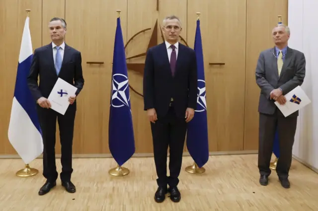 Finland's Ambassador to NATO Klaus Korhonen, NATO Secretary-General Jens Stoltenberg and Sweden's Ambassador to NATO Axel Wernhoff attend a ceremony to mark Sweden's and Finland's application for membership in Brussels, Belgium, 18 May 2022.