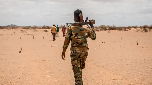 A soldier walks through a camp for displaced people on the outskirts of Dollow, Jubaland.