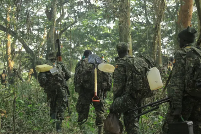 Ugandan People's Defence Forces (UPDF) soldiers patrol in the Virunga National Park on December 14, 2021