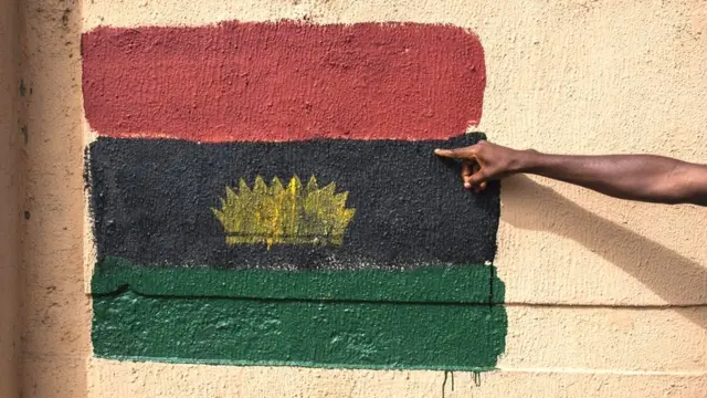 The Biafran separatist flag painted on a wall.