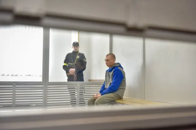 Russian serviceman Vadim Shishimarin sits in the dock on the second day of his war crimes trial in the Solomyansky district court in Kyiv, Ukraine, 19 May 2022.