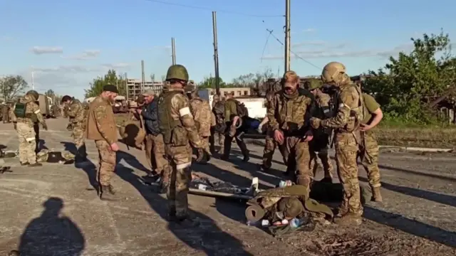 Ukrainian soldiers from Mariupol pictured surrendering on 17 May, in a screen grab from a Russian defence ministry video