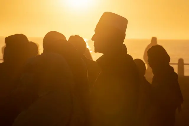 Muslim faithfuls gather at Seapoint to try and sight the new moon, which will mark the end of the Islamic holy fasting month of Ramadan, and start the celebration of Eid al-Fitr, in Cape Town, on May 1, 2022.