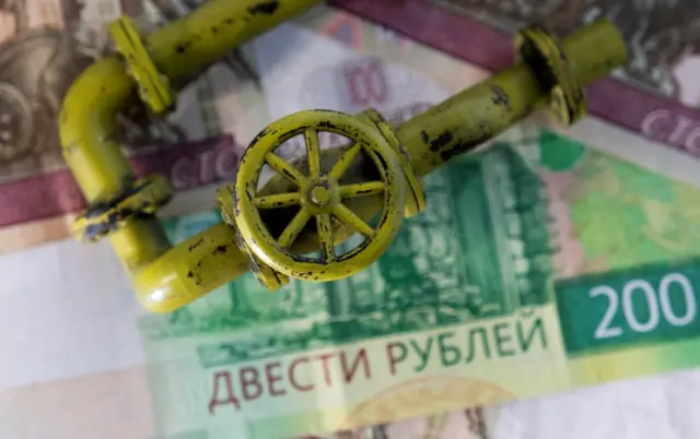 File image showing a miniature gas tap on top of Russian banknotes