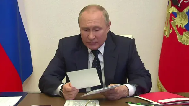 Russian President Vladimir Putin reading a statement