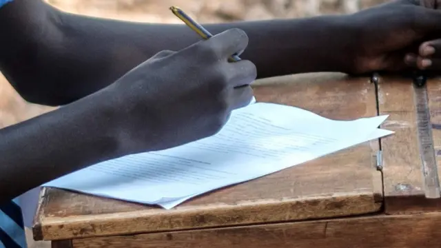 A student in Kenya writing an exam