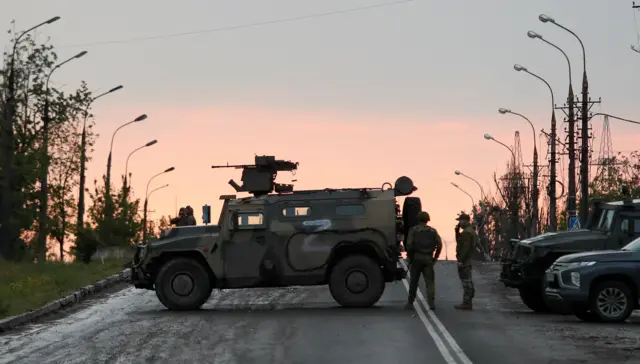 Pro-Russian troops standing guard at the plant as Ukrainian troops were removed from the site
