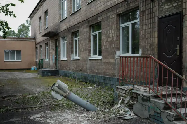 An unexploded ordnance is seen at a backdoor of a kindergarten